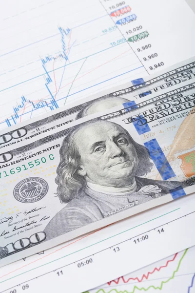 Stock market chart and 100 USA dollars bills - studio shot — Stock Photo, Image