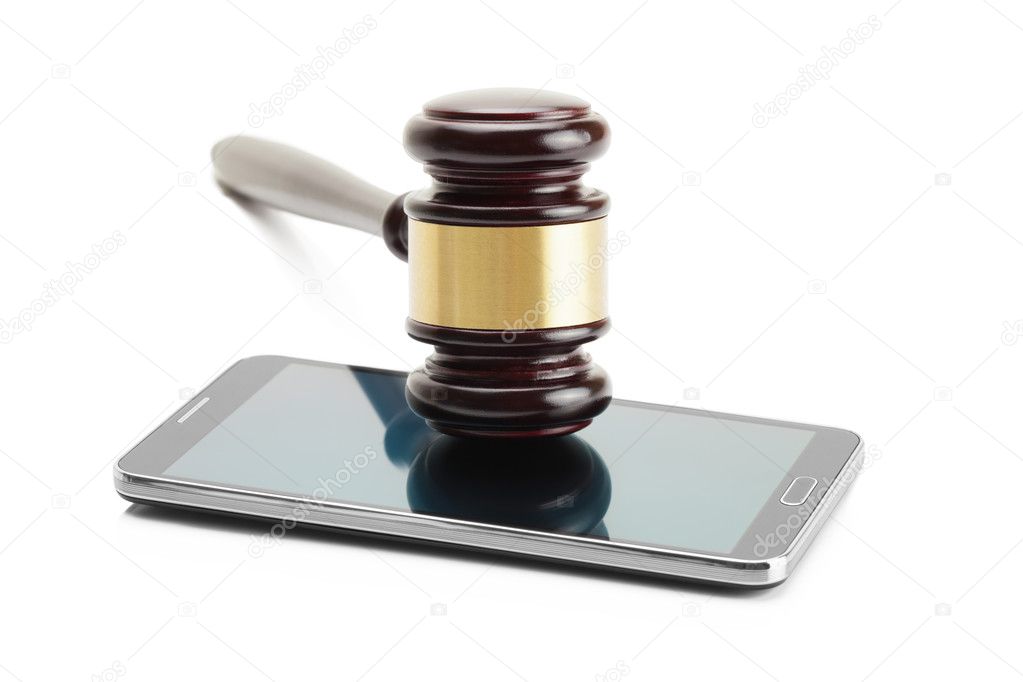 Judge gavel over smartphone and isolated on white background - studio shoot