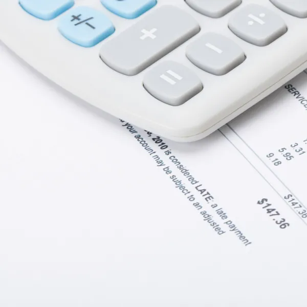 Calculator over utility bill - 1 to 1 ratio — Stock Photo, Image