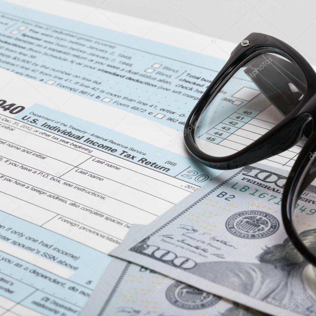 USA 1040 Tax Form with glasses and two 100 US dollar bills - 1 to 1 ratio