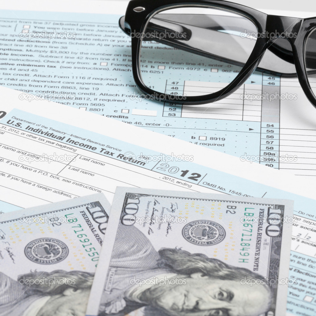 USA Tax Form 1040 with glasses, calculator and 100 US dollar bills - 1 to 1 ratio