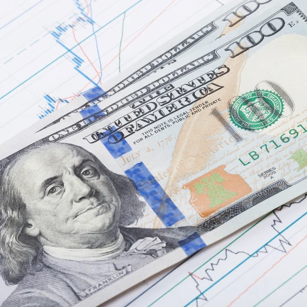 100 USA dollars banknote covering stock market chart - studio shot - 1 to 1 ratio — Stock Photo, Image
