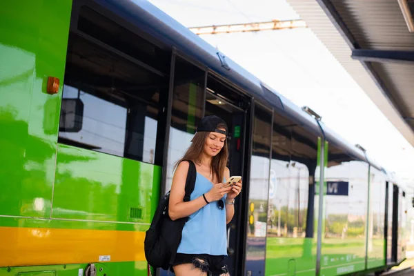 Young Athletic Woman Stands Smartphone Train Railway Station 로열티 프리 스톡 사진