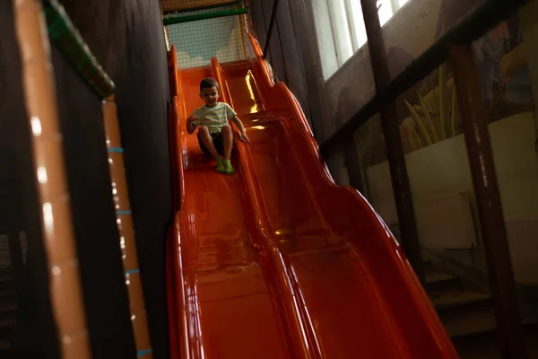 Child Boy Rides Plastic Orange Slide Children Play Center — Fotografia de Stock