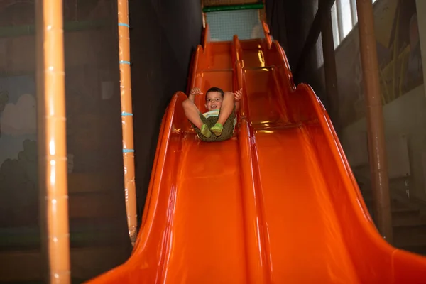 Child Boy Rides Plastic Orange Slide Children Play Center — Fotografia de Stock
