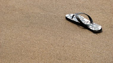 flip kayıp çift sandalet kumsalda floplar.