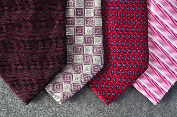 Four ties in tones of red, burgundy and pink — Stock Photo, Image