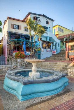 Guayaquil, Guayas, Ecuador - November, 2013: A water fountain and local businesses and houses in the background, make a beautiful and colorful hike up to the Lighthouse a very nice experience.