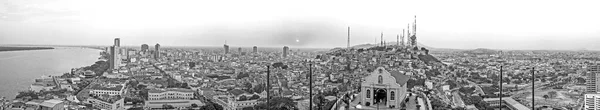 Panoramic photo in Black and White of the view of Guayaquil from the top of the lighthouse on the Cerro Santa Ana (Saint Ana hill), a moment before sunset after a warm sunny summer day. Ecuador.