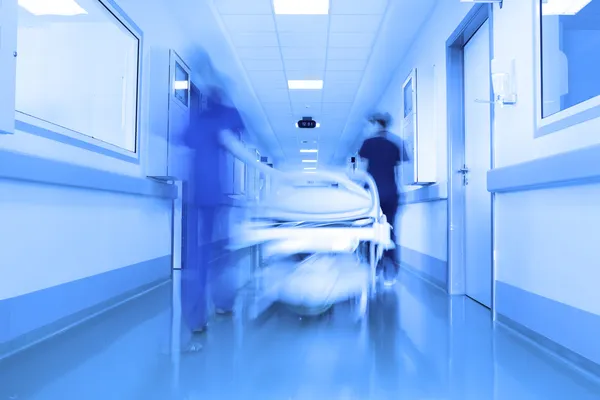 Bed in a modern clinic corridor — Stock Photo, Image