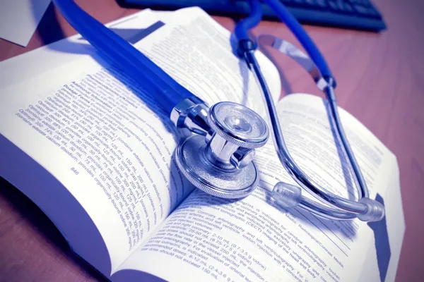 Open book and stethoscope, medical symbols. stylized photos. — Stock Photo, Image