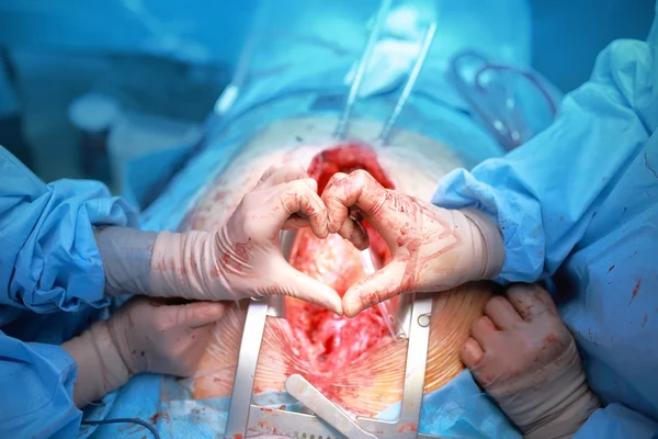 Hand surgeons in the shape of heart — Stock fotografie