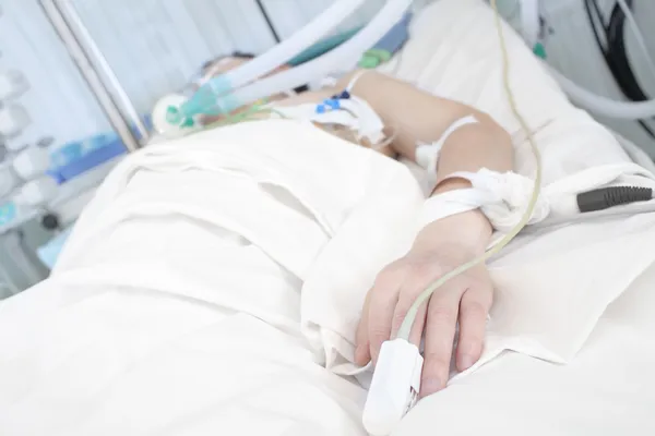 Patient in bed. Hand in focus — Stock Photo, Image