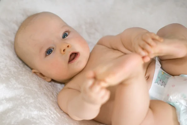 Bebeğin ayakları ile oynuyor