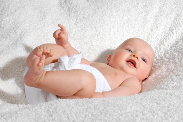 Baby plays with his feet — Stock Photo, Image