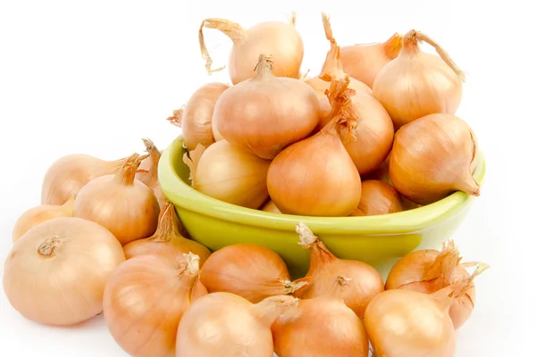 A bowl full of onions on white background Stock Image