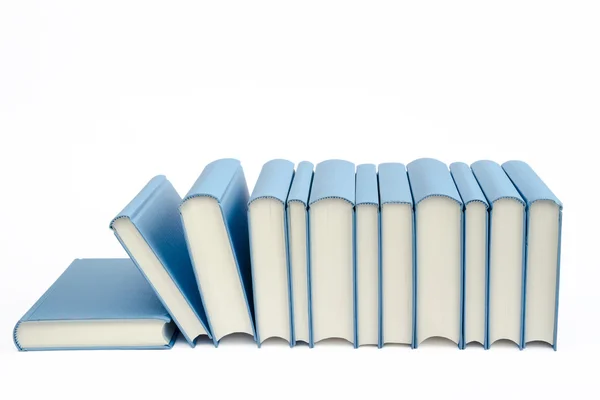 A group of blue books in a row on a white background — Stock Photo, Image