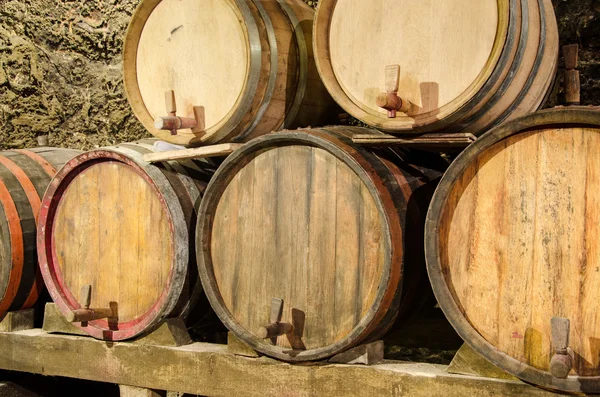 Wooden wine barrels in an underground cellar — Stock Photo, Image