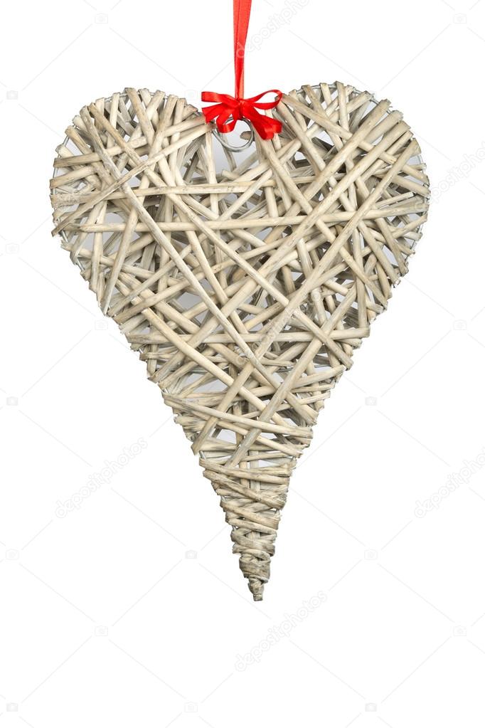Wooden handmade heart and red ribbon on a white background