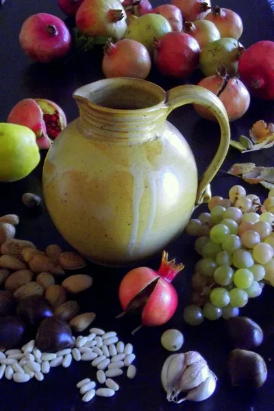 Water jug with autumn fruit — Stock Photo, Image