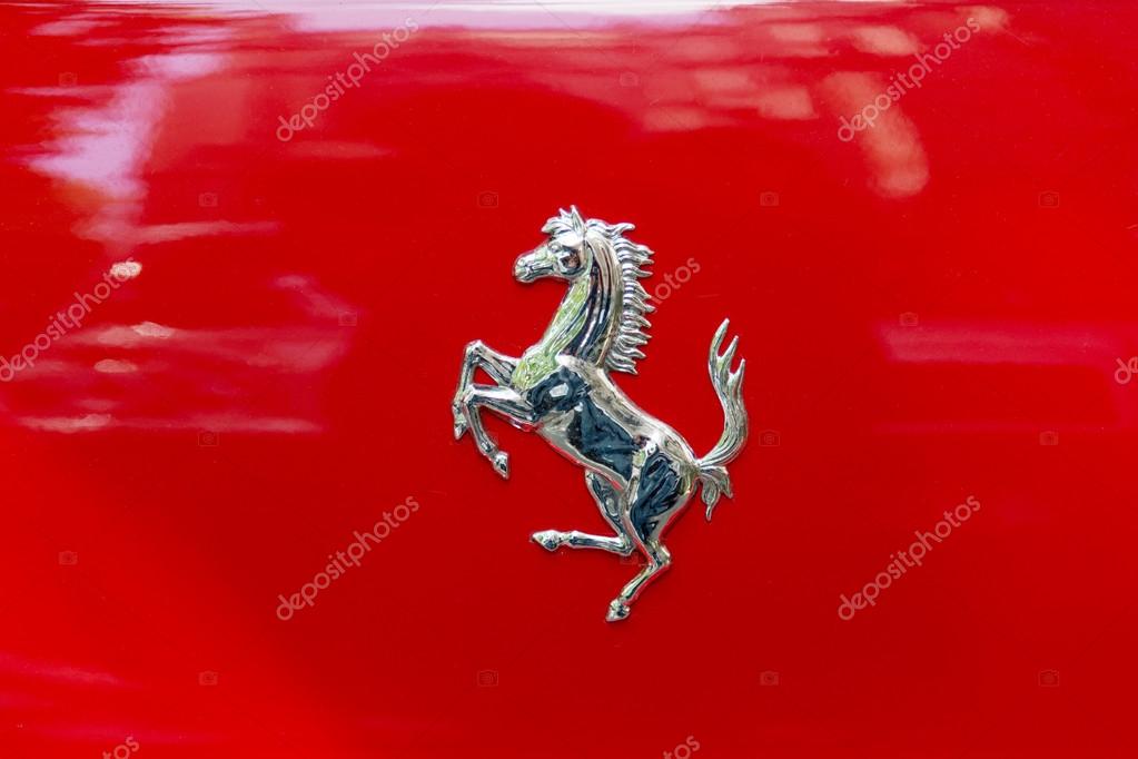 Prancing Horse logo on the shield of rosso corsa painted Ferrari car
