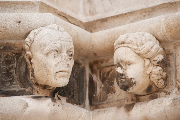 Sculptured heads of St James Cathedral — Stock Photo, Image