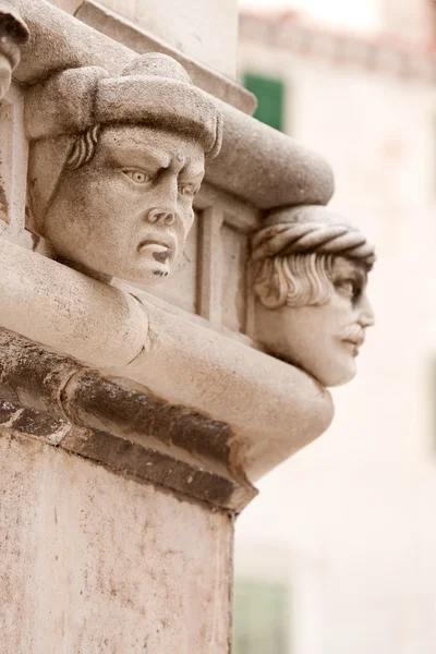 Sculptured heads of St James Cathedral — Stock Photo, Image