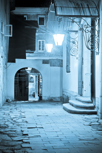 Courtyard of historical buildings in Lviv at night
