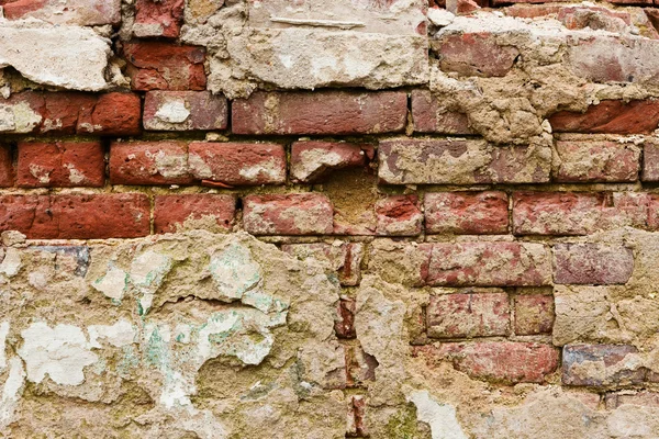 Old crumbling plastered brick wall — Stock Photo, Image