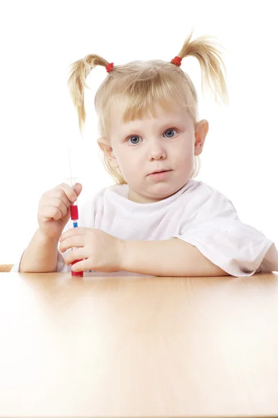 Child playing with a syringe — Stock Photo, Image