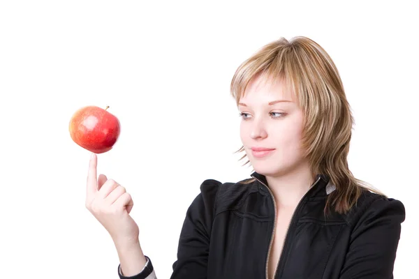 Girl holds an apple on a finger — Stock Photo, Image