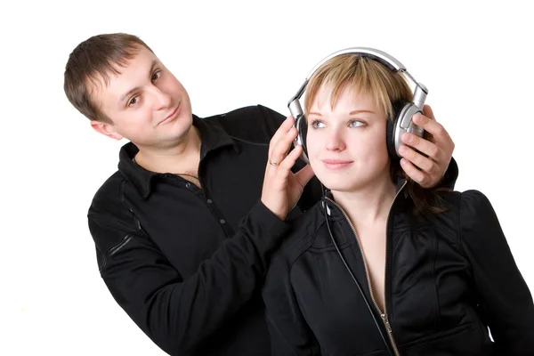 Young happy amorous couple with headphones at home — Stock Photo, Image