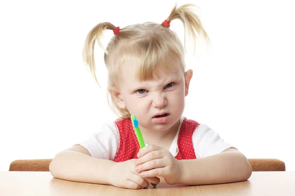 Displeased child with toothbrush — Stock Photo, Image