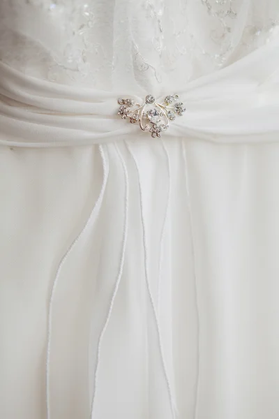 Part of a dress with brooch — Stock Photo, Image