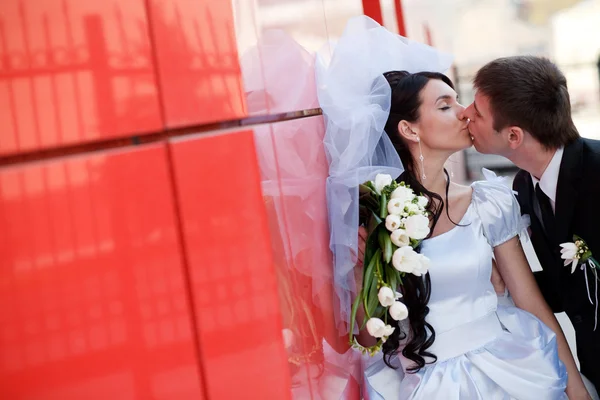 Beijo pela parede vermelha — Fotografia de Stock