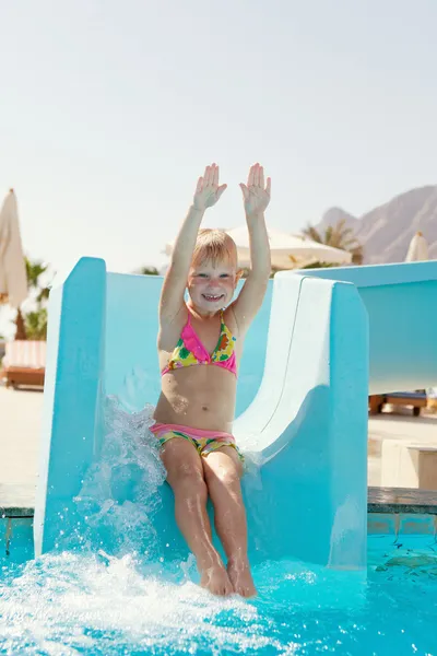 Happy little girl on slide — Stock Photo, Image