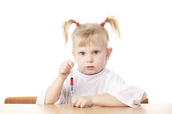 Child playing with a syringe — Stock Photo, Image