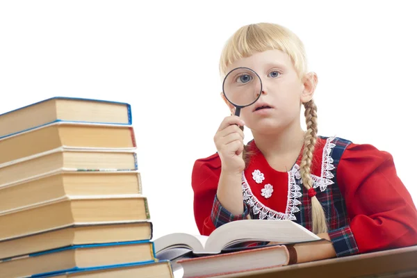 Girl reading with loupe — Stock Photo, Image