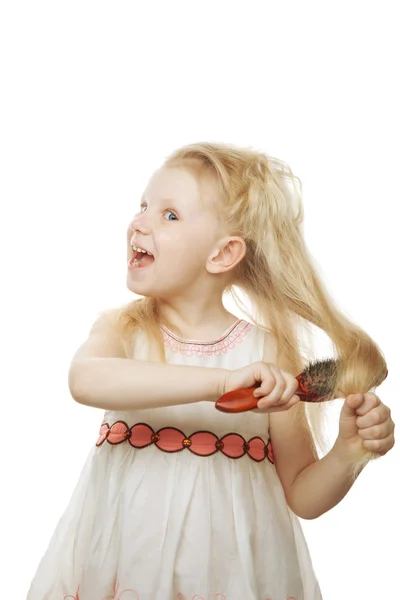 Laughing girl combing her hair — Stock Photo, Image