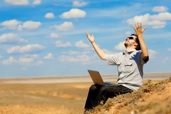 Man with laptop praying to the God — Stock Photo, Image