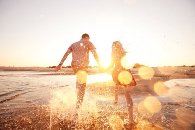 couple running on the beach clipart