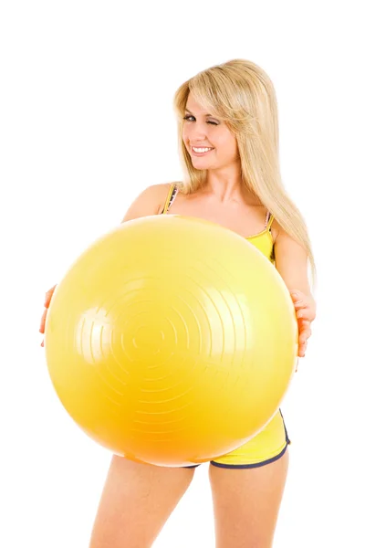 Winking girl with a ball for fitness — Stock Photo, Image