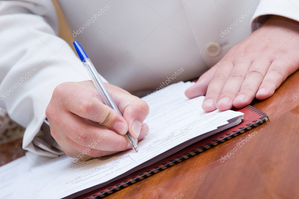 man signing paper