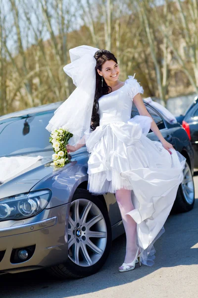 Bride by the car — Stock Photo, Image