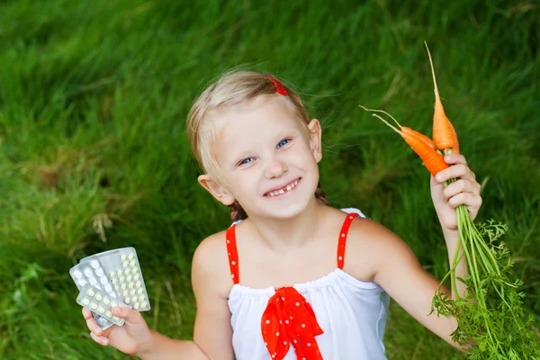 Girl with medicine and carrots — Stock Photo, Image