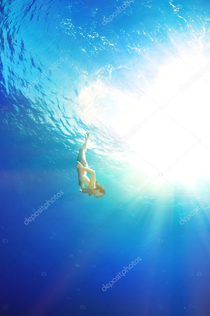 girl diving under the sea