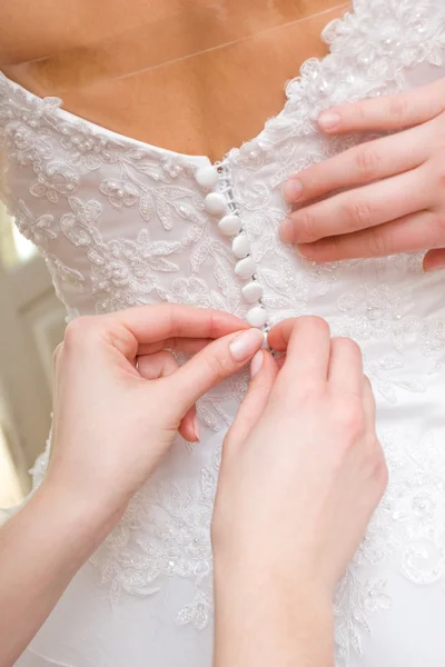 Girls lace up a wedding dress of the bride — Stock Photo, Image