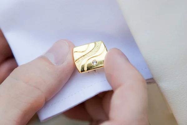 Putting on cuff link — Stock Photo, Image