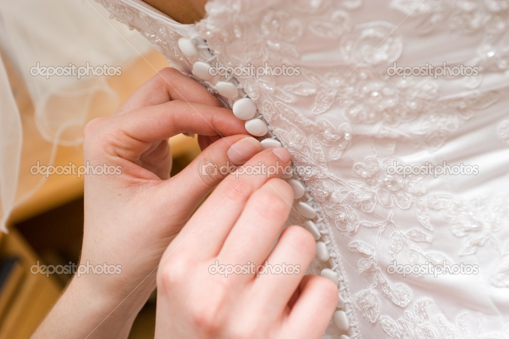 poner en un vestido de novia con botones — foto de stock © vsurkov