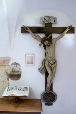 Statue of the Crucified Christ  in the Cathedral and The old  holy open book. Christian symbolism. 